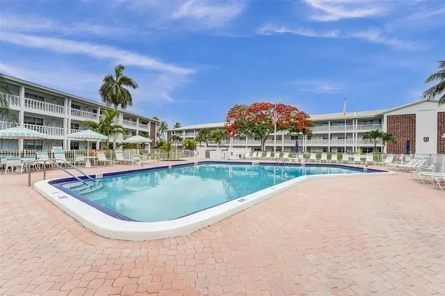 a view of a house with a swimming pool and a yard