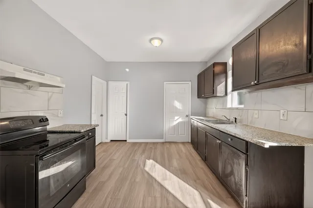 a kitchen with stainless steel appliances granite countertop a sink a microwave counter space and cabinets