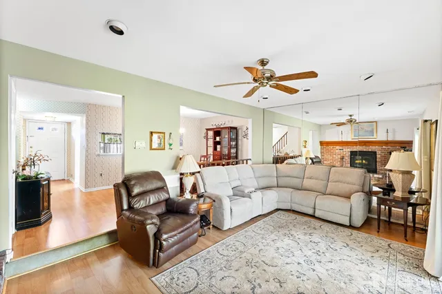 a living room with furniture ceiling fan and a rug