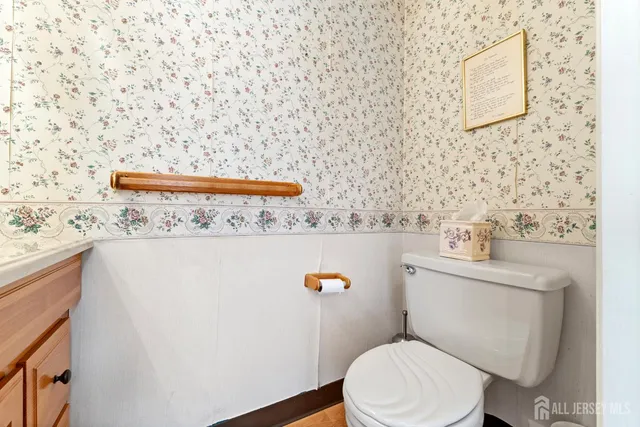 a bathroom with a sink a toilet and mirror