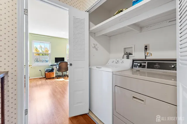 a view of a bedroom with a washer and dryer