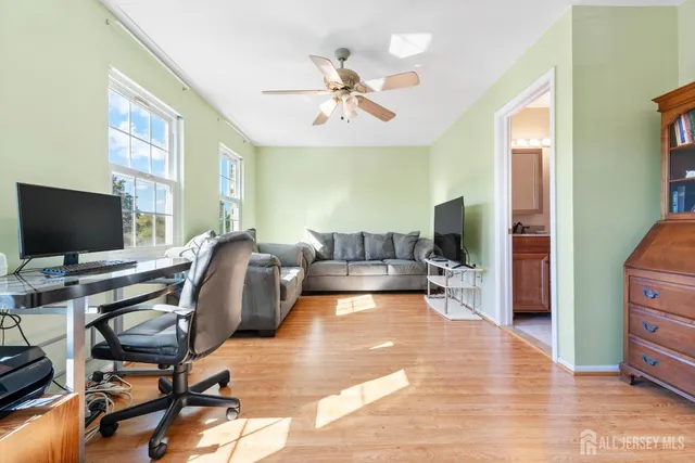 a view of a livingroom with furniture and a flat screen tv