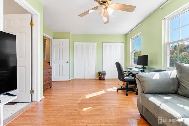 a view of a livingroom with workspace and a window