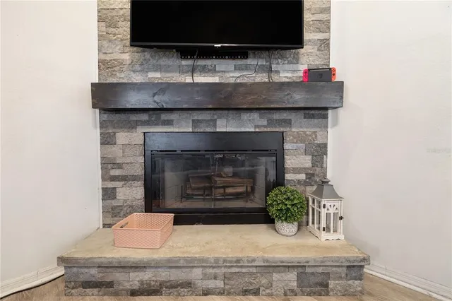 a kitchen with a fireplace and a potted plant