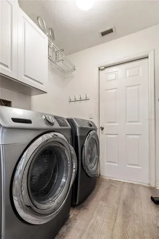 a utility room with sink dryer and washer