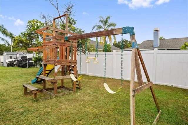 a view of a house with a backyard patio and swimming pool