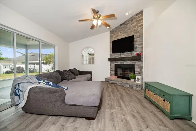 a living room with furniture fireplace and flat screen tv