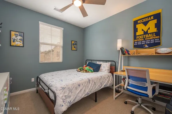 a bedroom with a bed and a desk