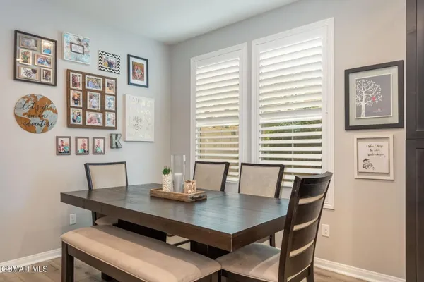 a view of a dining room with a table and chairs