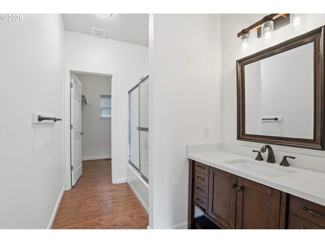 a bathroom with a sink vanity and a mirror