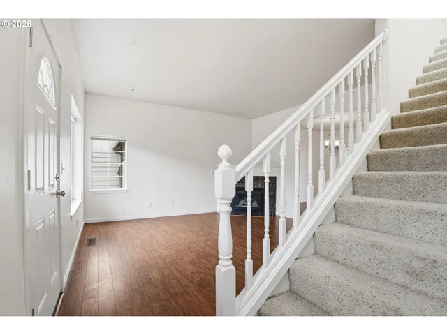 a view of an entryway with wooden floor
