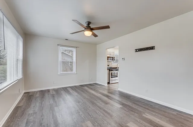 wooden floor in an empty room with a window