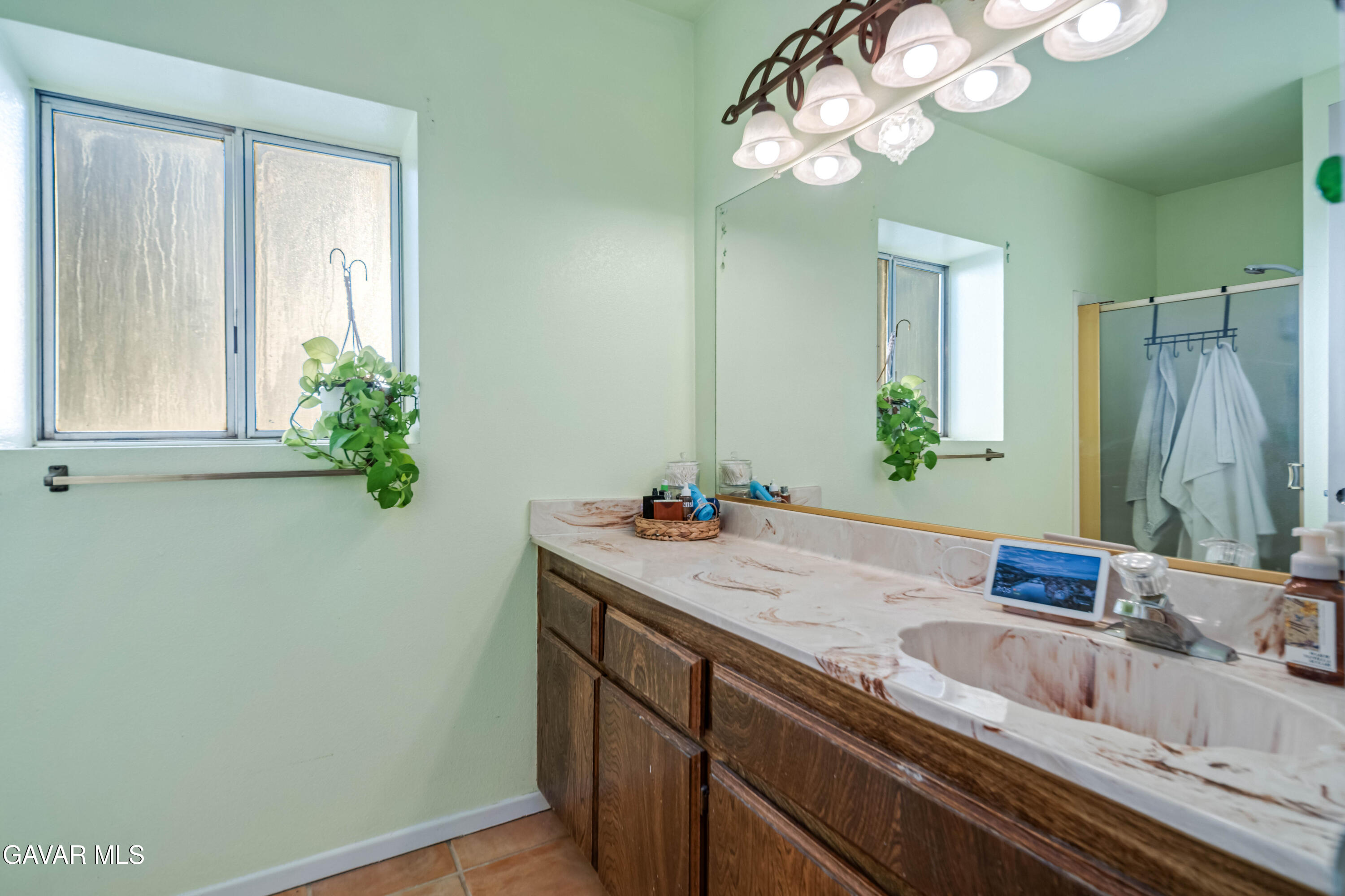 20539 East Ave R Palmdale, CA 93591 - Photo 29 of 55 a bathroom with a sink a vanity and a mirror