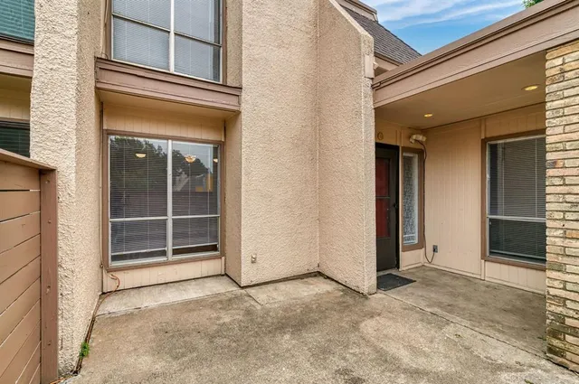 a view of a hallway with closet and front door
