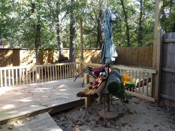 a view of a wooden deck with chairs and a yard