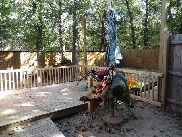 a view of a wooden deck with chairs and a yard