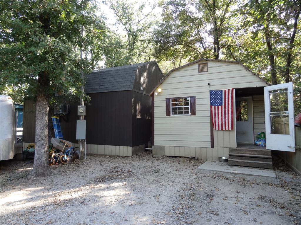 126 Deer Run Road Mabank, TX 75156 - Photo 20 of 20 a small barn with a large window and potted plants in the back yard