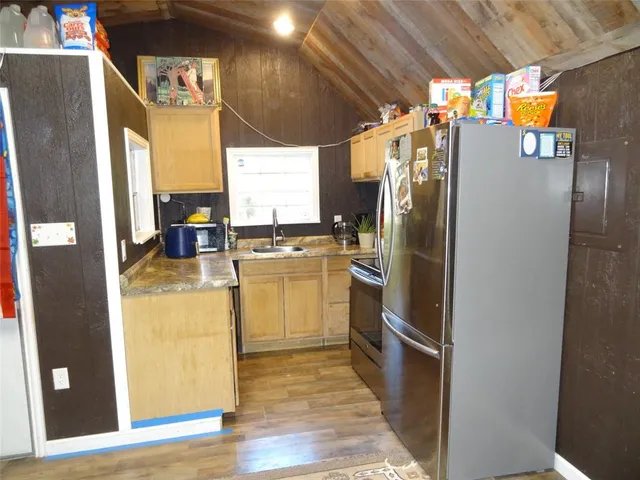 a kitchen with a refrigerator and countertop