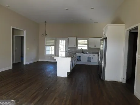 a kitchen with stainless steel appliances a refrigerator sink and cabinets