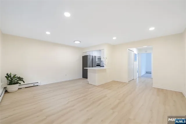 a view of kitchen with wooden floor and electronic appliances