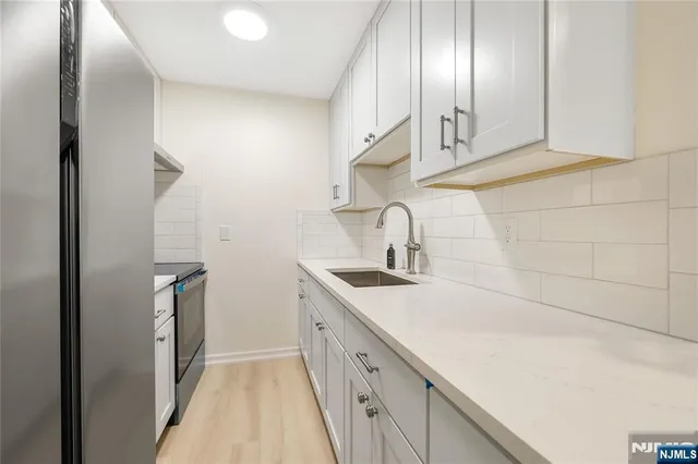 a kitchen with a sink and cabinets