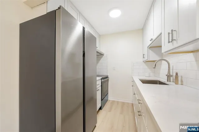 a kitchen with a sink and refrigerator
