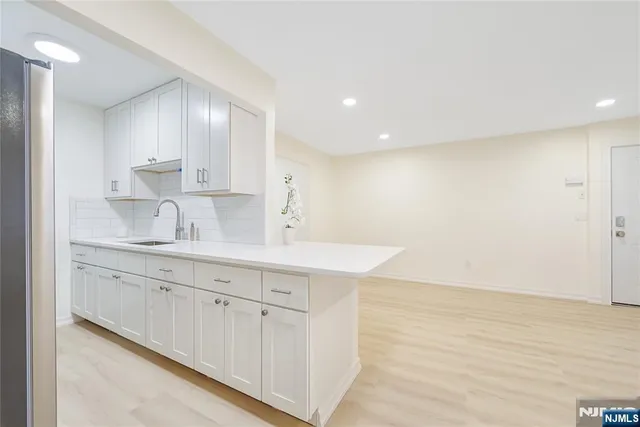 a kitchen with white cabinets