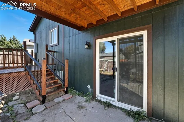a roof deck with wooden floor and fence