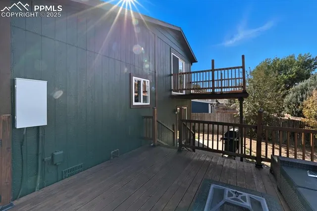 a view of a roof deck with furniture
