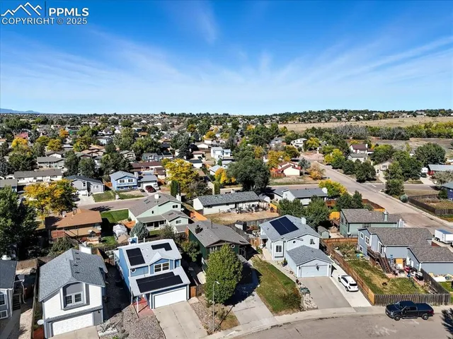 an aerial view of a building with outdoor space and ocean view