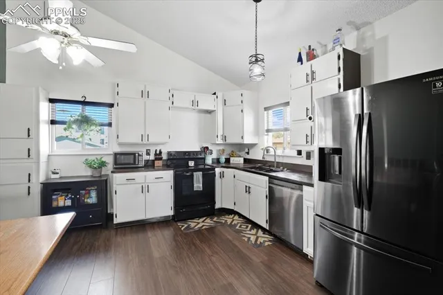 a kitchen with stainless steel appliances kitchen island granite countertop a refrigerator a sink dishwasher a stove and a refrigerator