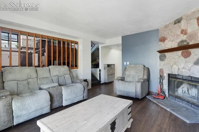 a living room with furniture and a fireplace