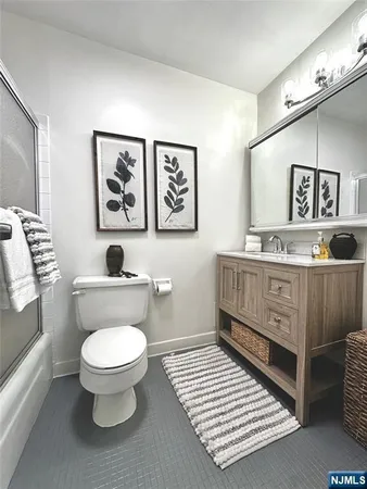 a bathroom with a toilet a sink and a window