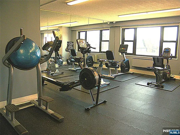 a room with gym equipment and large mirror
