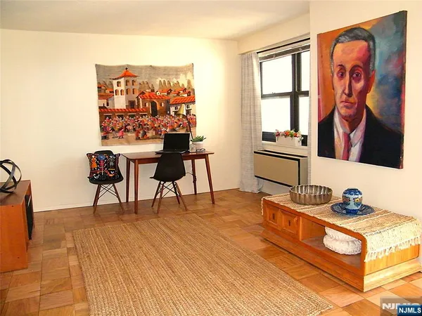 a living room with furniture and a wall painting