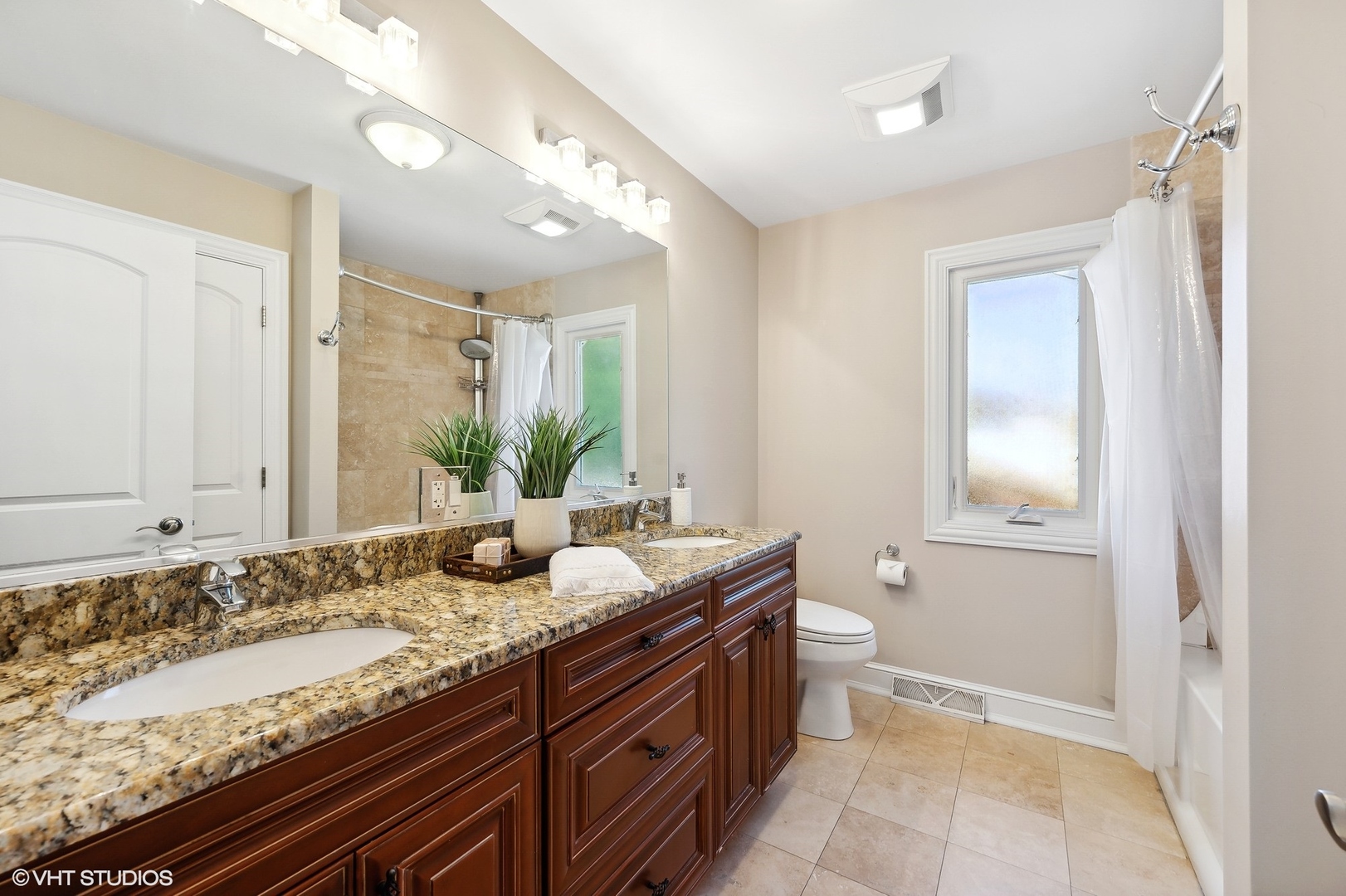 2736 Glenview Road Glenview, IL 60025 - Photo 21 of 31 a bathroom with a granite countertop sink a toilet a large mirror and vanity