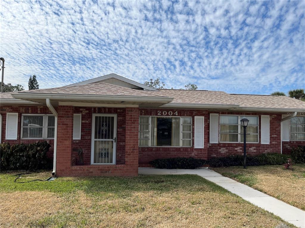 a front view of a house with a garden and porch