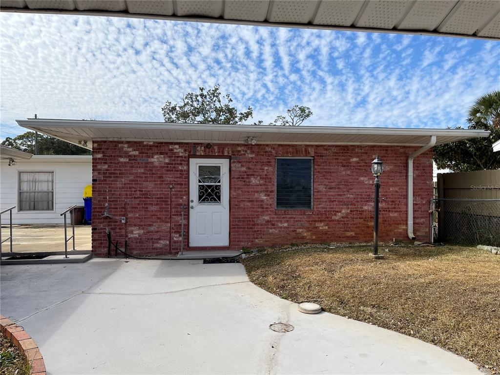 2004 South Riverside Drive Edgewater, FL 32141 - Photo 5 of 9 a front view of a house with garden