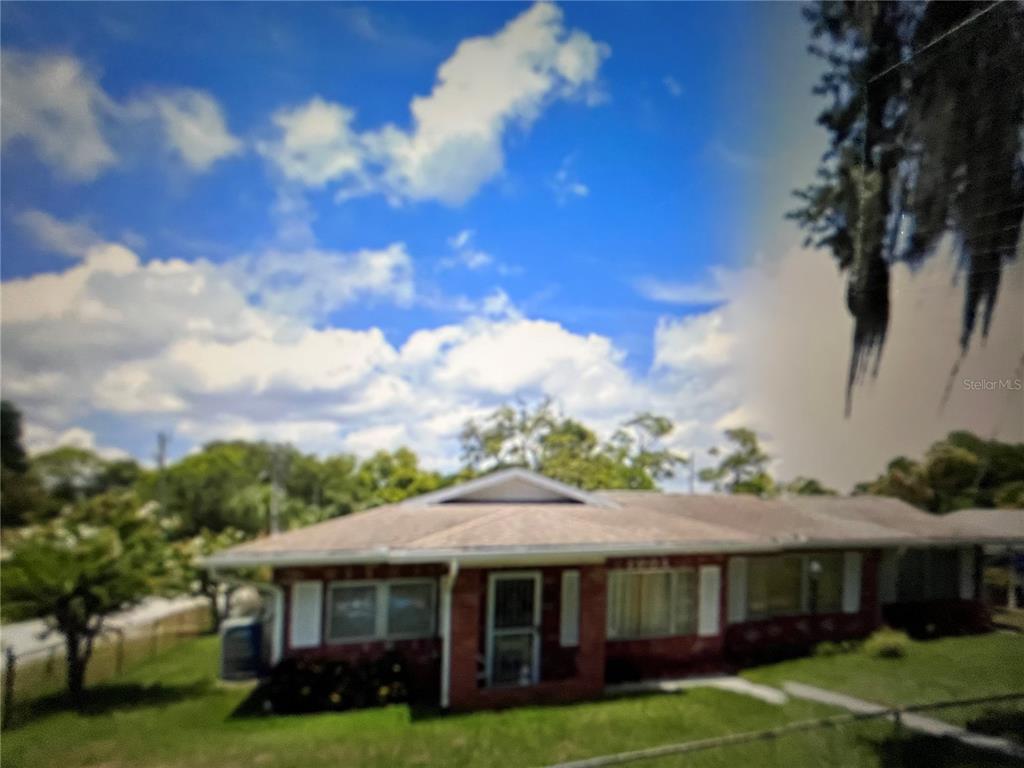 2004 South Riverside Drive Edgewater, FL 32141 - Photo 8 of 9 a front view of a house with a garden