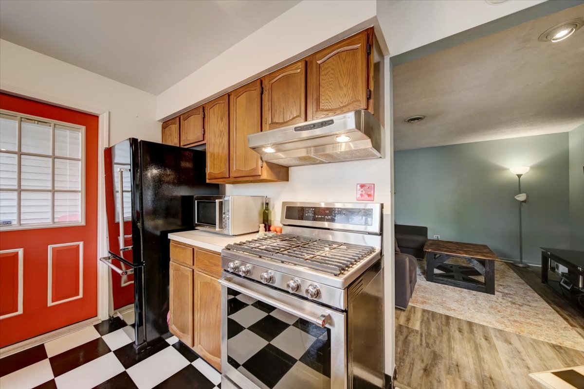 8325 High Point Circle, Unit A Darien, IL 60561 - Photo 11 of 42 a kitchen with a stove a sink and a refrigerator