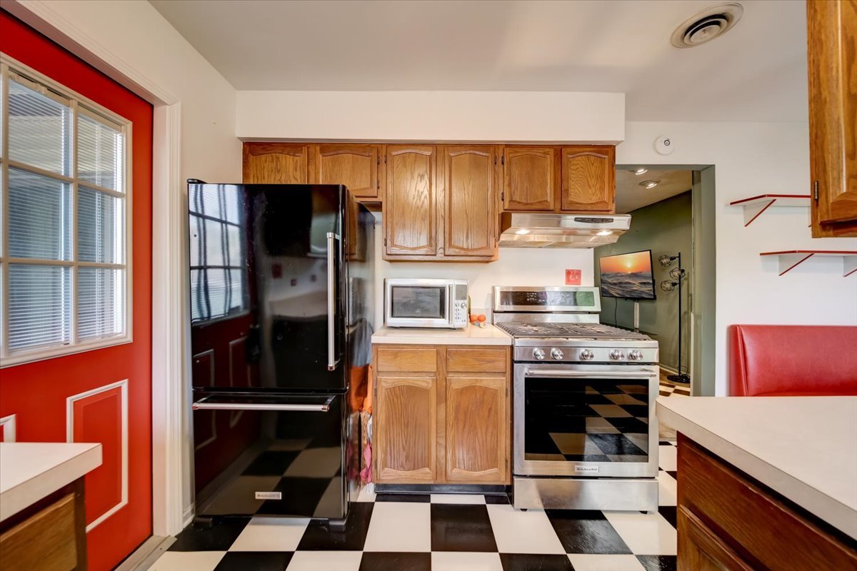 8325 High Point Circle, Unit A Darien, IL 60561 - Photo 12 of 42 a kitchen with stainless steel appliances granite countertop a refrigerator and a stove top oven