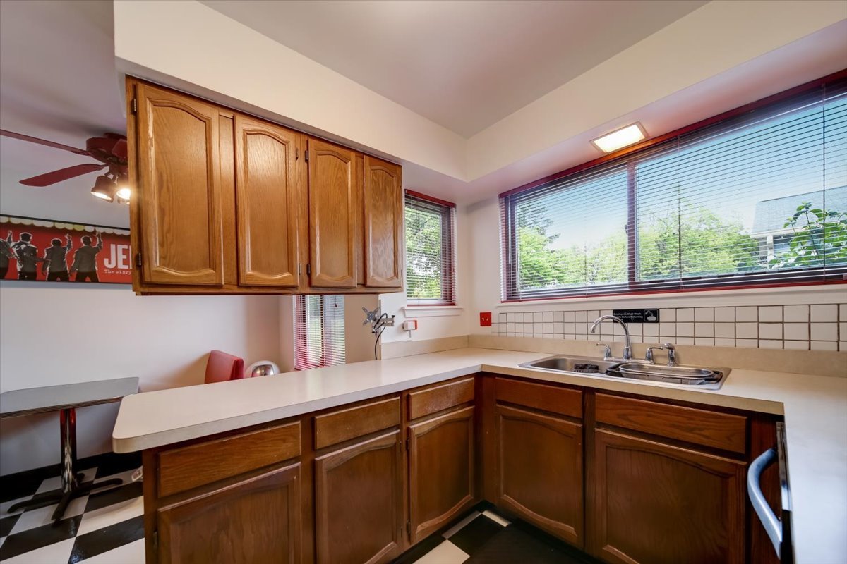 8325 High Point Circle, Unit A Darien, IL 60561 - Photo 14 of 42 a kitchen with a sink window and cabinets