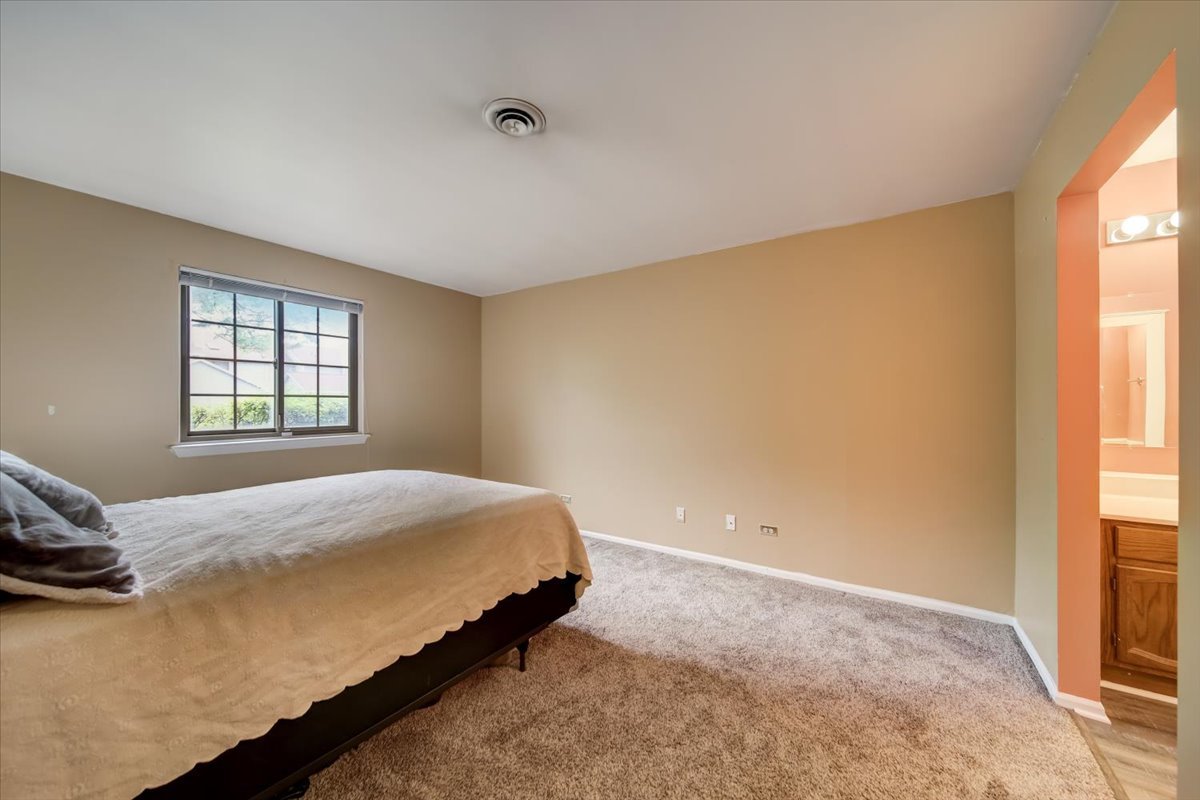8325 High Point Circle, Unit A Darien, IL 60561 - Photo 15 of 42 a bedroom with a bed and a window