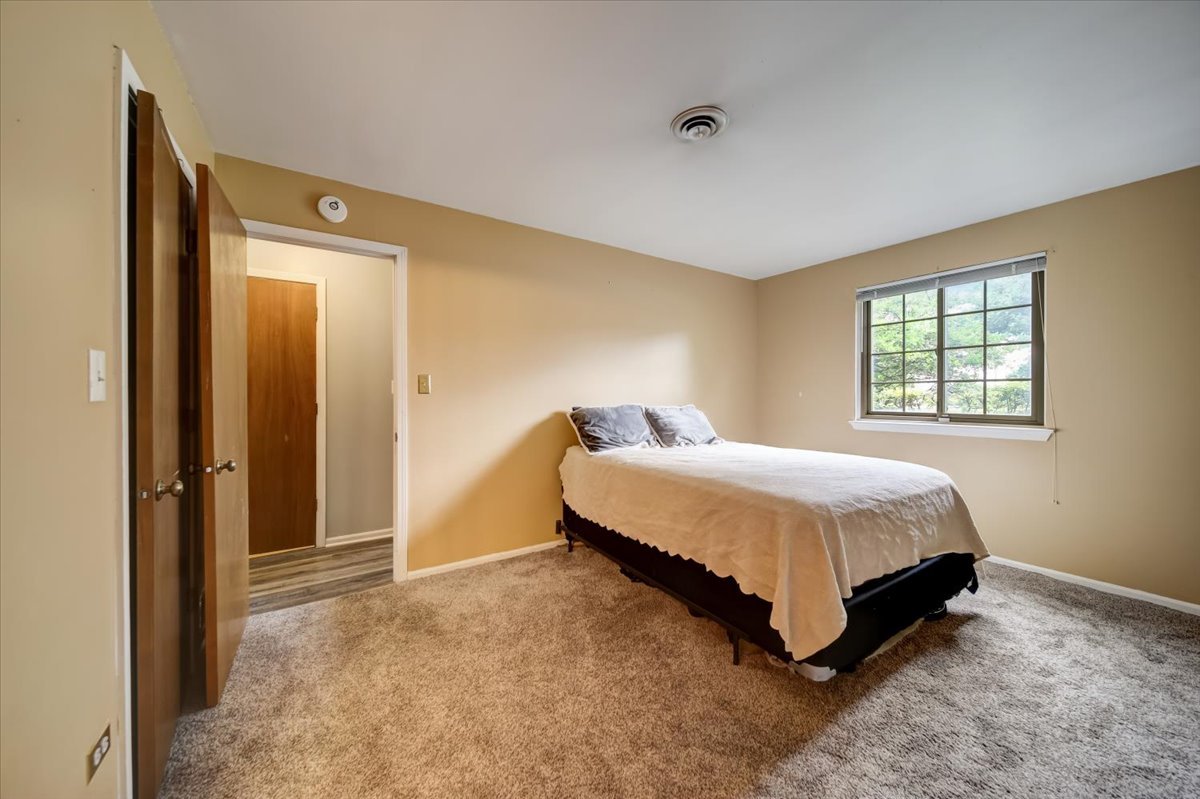 8325 High Point Circle, Unit A Darien, IL 60561 - Photo 16 of 42 a spacious bedroom with a bed and a window