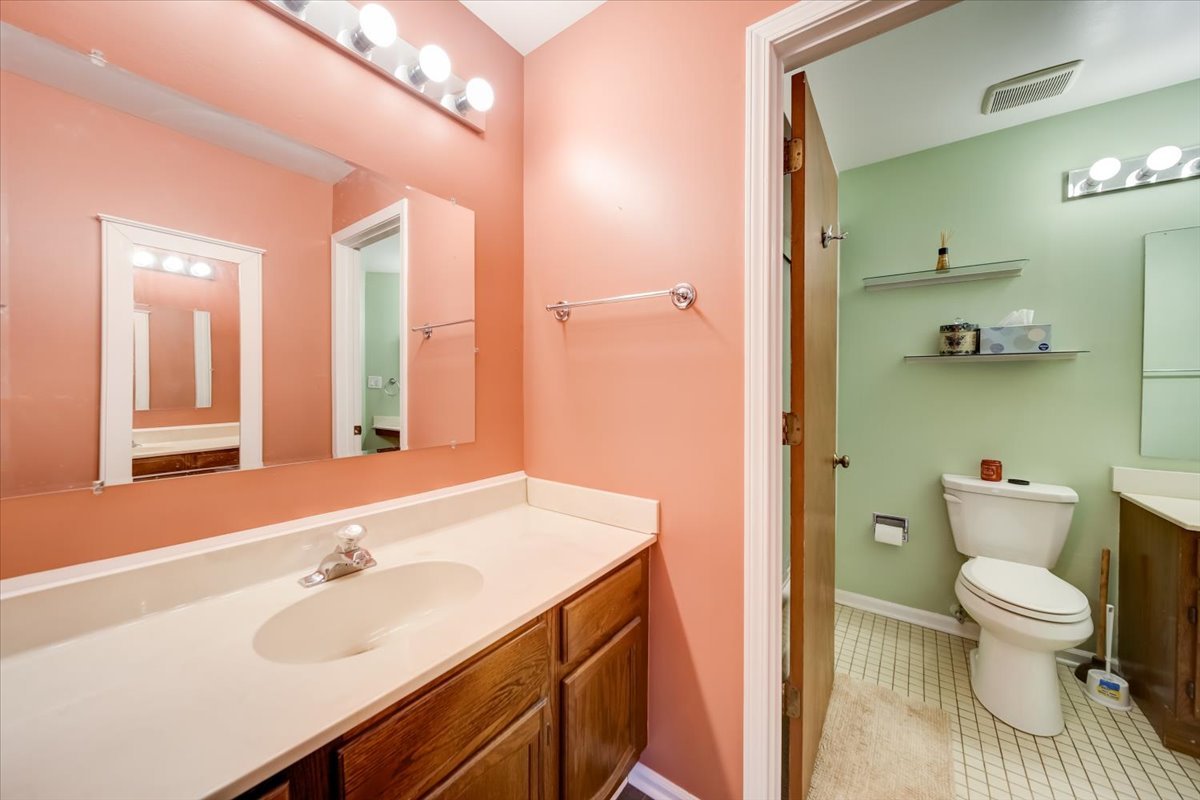 8325 High Point Circle, Unit A Darien, IL 60561 - Photo 20 of 42 a bathroom with a sink a toilet and shower