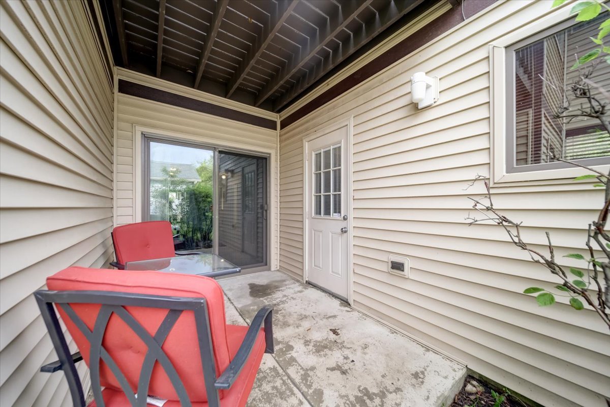 8325 High Point Circle, Unit A Darien, IL 60561 - Photo 27 of 42 a balcony with table and chairs