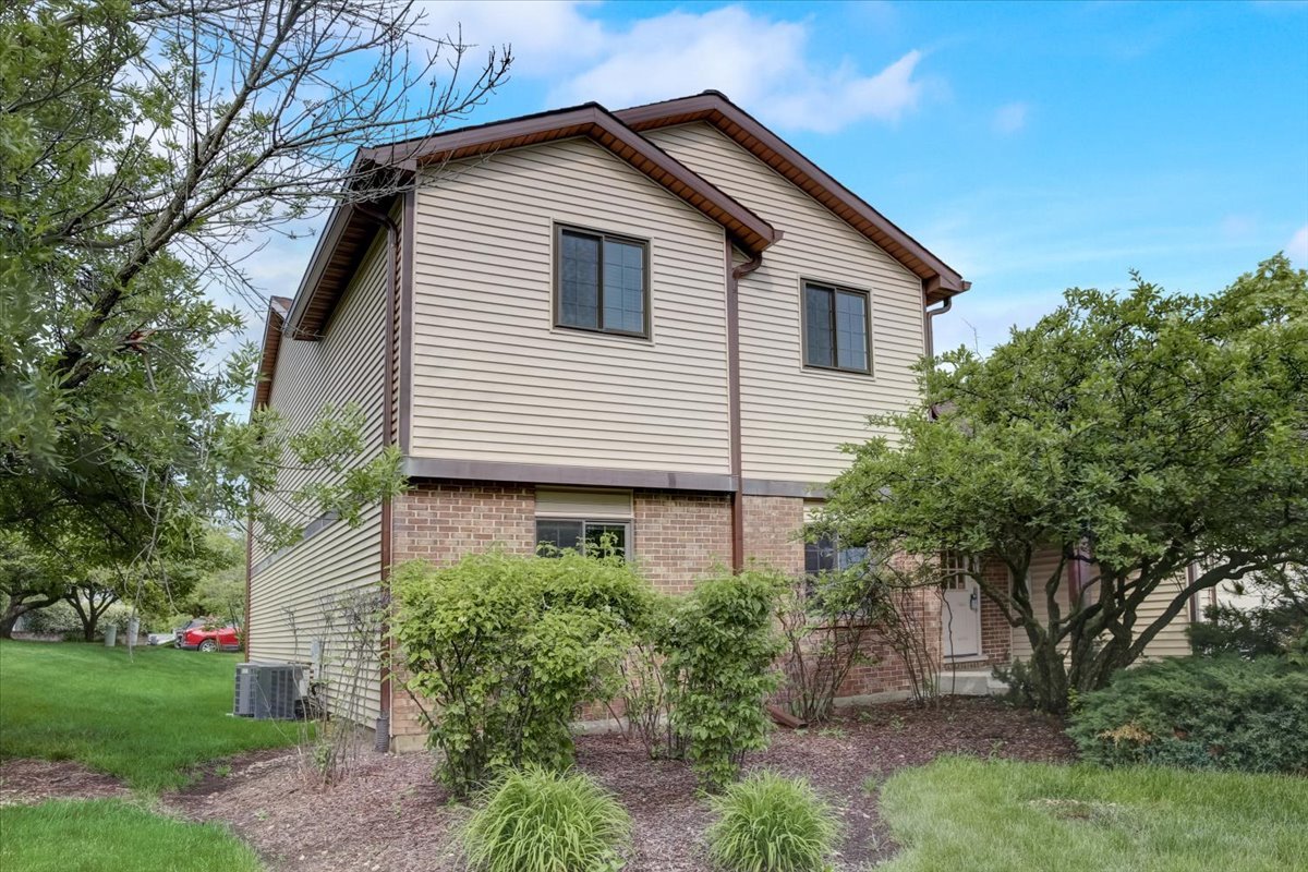 8325 High Point Circle, Unit A Darien, IL 60561 - Photo 30 of 42 a view of a house with a yard and potted plants