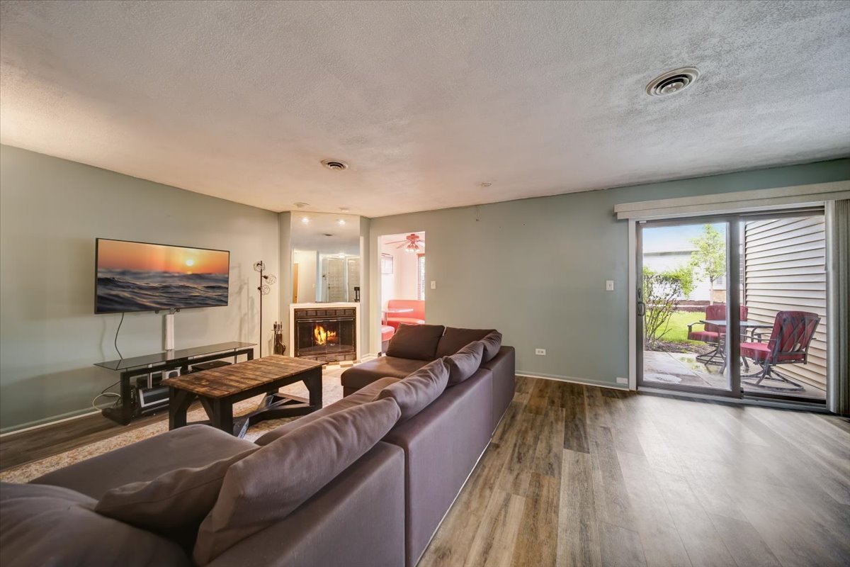 8325 High Point Circle, Unit A Darien, IL 60561 - Photo 3 of 42 a living room with furniture and a flat screen tv