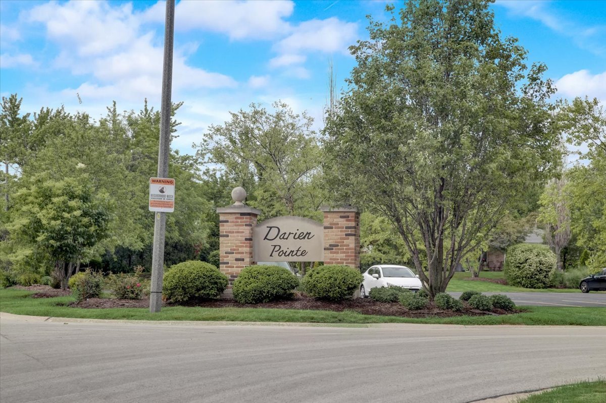 8325 High Point Circle, Unit A Darien, IL 60561 - Photo 32 of 42 a front view of a house with a yard and mountain view