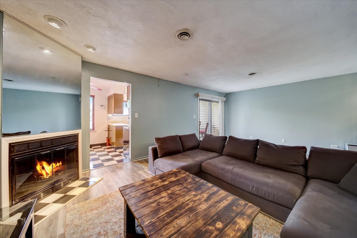 8325 High Point Circle, Unit A Darien, IL 60561 - Photo 4 of 42 a living room with furniture a fireplace and a rug